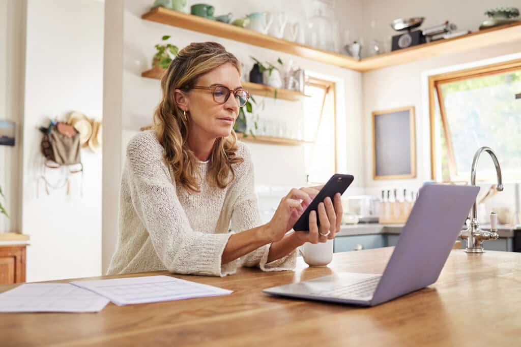 Business owner reviewing financial records and bookkeeping information with accounting software.